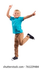LITTLE BOY STANDING, POINTING FINGER, DANCING AND SMILING HAPPY ISOLATED ON WHITE BACKGROUND