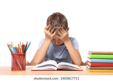 Little boy with stationery and books suffering from dyslexia at wooden table - Powered by Shutterstock