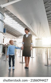 Little Boy And Stewardess Holding Hands At The Airport