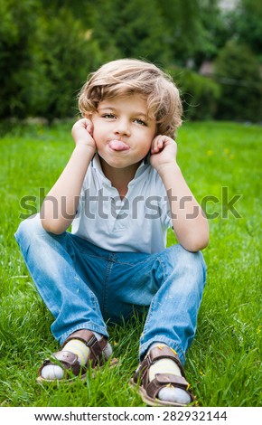 Similar – Cute little boy seated on the wall of a castle