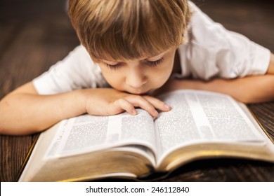 little boy studying the scriptures. - Shutterstock ID 246112840