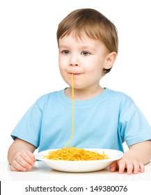 Little Boy Is Sucking Up A Single Spaghetti Strand, Isolated Over White