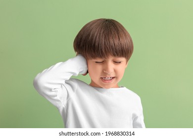 Little Boy Suffering From Ear Pain On Color Background