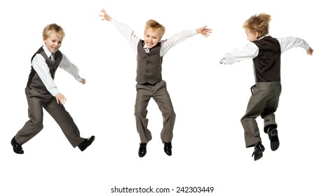 Little Boy In Suit Jumping On White Background 