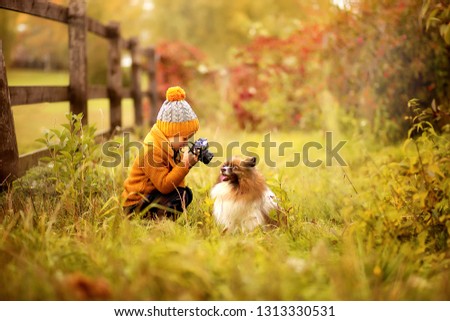 Similar – Foto Bild Herbstporträt eines glücklichen Kindes Mädchens, das mit ihrem Hund spielt.