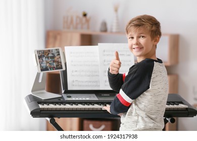 Little boy taking music lessons online at home - Powered by Shutterstock