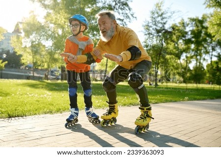Little boy teaching his father riding roller skates in park