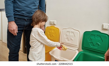 Little Boy Throwing Papers In Dustbin For Paper Near Cropped Parents At Home. Ecological Garbage Recycle. Parenting. Family Relationship And Spending Time Together. Modern Domestic Lifestyle