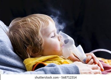 Little boy toddler makes inhalation with a nebulizer at home - Powered by Shutterstock