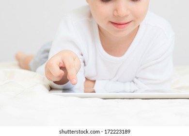  Little boy with touch pad, early education and modern technology