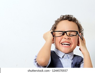 Little Boy Trying On A Pair Of Glasses Stock Photo