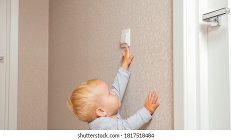 Little Boy Turns On The Light Switch