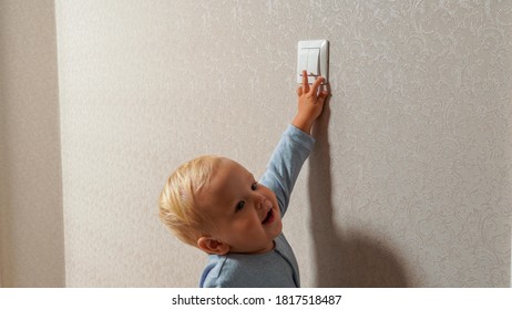 Little Boy Turns On The Light Switch