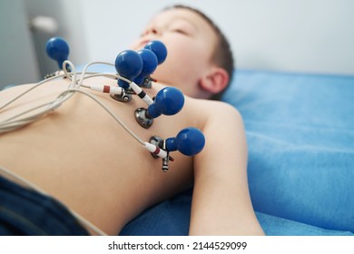 Little Boy Undergoing Electrocardiogram Test In Clinic