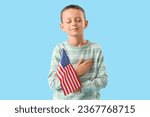 Little boy with USA flag on blue background. Veterans Day celebration