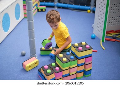 Little Boy Using Blocks Building Rocket. Kids Learning And Development Concept. Sensory Room, Independent Play