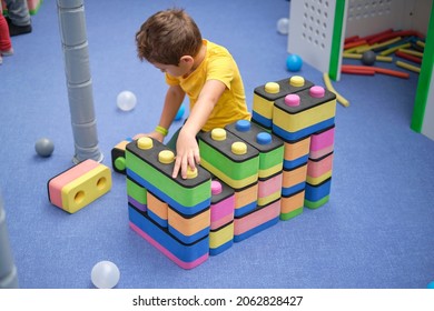 Little Boy Using Blocks Building Rocket. Kids Learning And Development Concept. Sensory Room, Independent Play