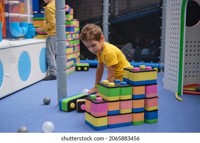 Little Boy Using Blocks Building Rocket. Kids Learning And Development Concept. Sensory Room, Independent Play