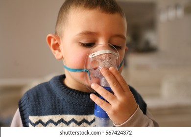 Little Boy Using Inhaler At Home. 