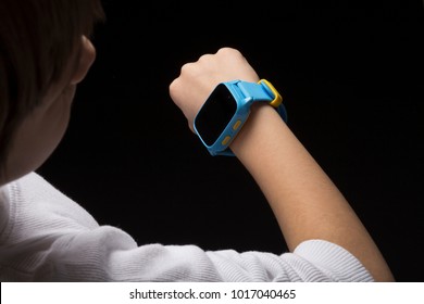 Little Boy Using Smartwatch To Call Parents. Wearable Children Tracking Gadget With Touch Screen And Voice Service, Electronic Wristband For Children