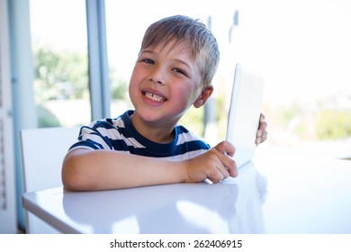 Little boy using tablet pc in the living room at home