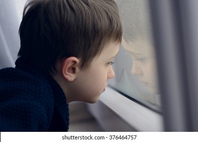 Little boy waiting by window for stop raining. Loneliness and waiting concept. Rainy day
 - Powered by Shutterstock