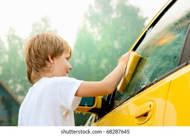 Little boy washing car. Summer. Sunset - Powered by Shutterstock