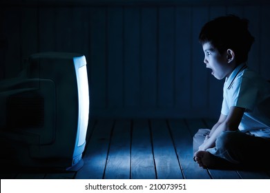 Little Boy Watching TV One Night On The Floor