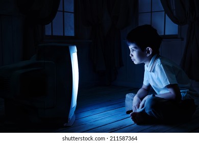 Little Boy Watching TV One Night On The Floor