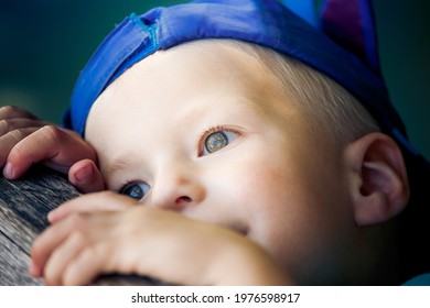 A Little Boy  Wearing His Favourite Baseball Cap, Hat Looking Sad And Fed Up At The Park