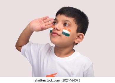 Little boy wearing Indian Flag Tshirt, face painted with Tricolour and saluting. Celebrating Independence day