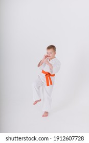little boy in a white kimono makes a punch on a white background with space for text. Vertical orientation
