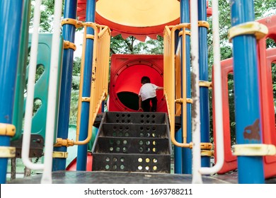 Little Boy In White T-shirt Play The Colorful Castle Toy In The Playground.