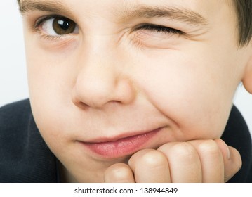 Little Boy Wink Of An Eye. Close Up Studio Shot