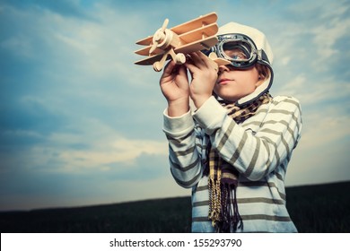 Little boy with wooden plane