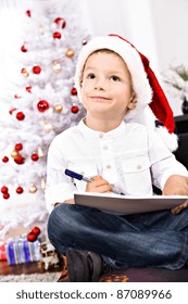 A Little Boy Writing A Letter To Santa