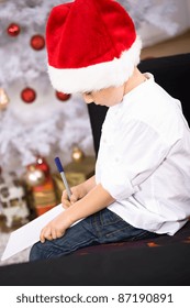 A Little Boy Writing A Letter To Santa