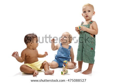 Little boys constructing a toy house with wooden colored bricks