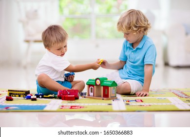 Little Boys Fighting Over Toy Car. Boy Playing Toy Cars On Play Mat. Young Kid With Vehicle And Transport Toys On Carpet. City Street Map Rug. Child Driving Car To Parking Garage. Kids Learn To Share.