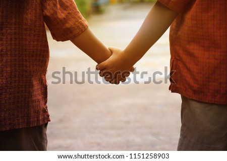 little boys holding hands. friendship and love concept. two boys student holding hands and walking together