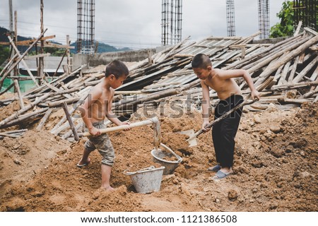 Little boys labor working in commercial building structure, World Day Against Child Labour concept.