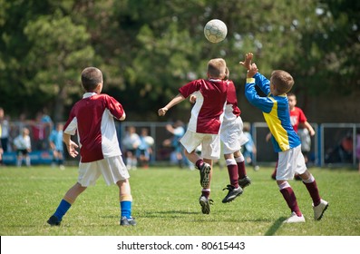 Little Boys Playing Soccer On The Sports Field