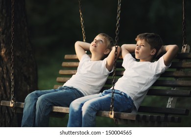 Little Boys Riding On A Swing