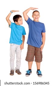 Little Boys Trying To Be Taller Isolated In White