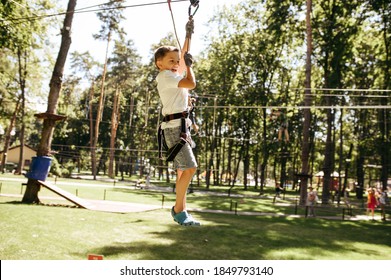 Little Brave Boy On Zipline In Rope Park