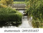 Little bridge over water. Beautiful summer scenery. Koitelinkoski, Kiiminki, Finland.