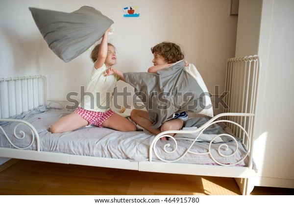 Little Brother Sister Staged Pillow Fight Stock Image