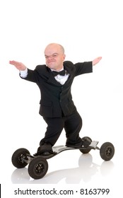 Little businessman, dwarf in a formal suit with bow tie surfing on skateboard, mountain board, studio shot, white background