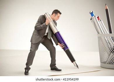 Little Businessman Sign With Giant Pen At Office