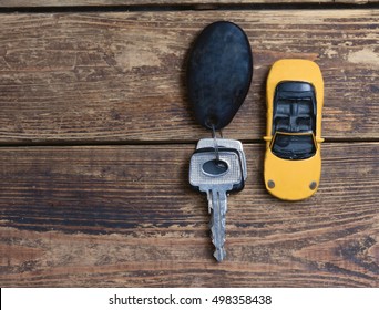 Little Car And Keys On A Wooden Table.view From Above.toned